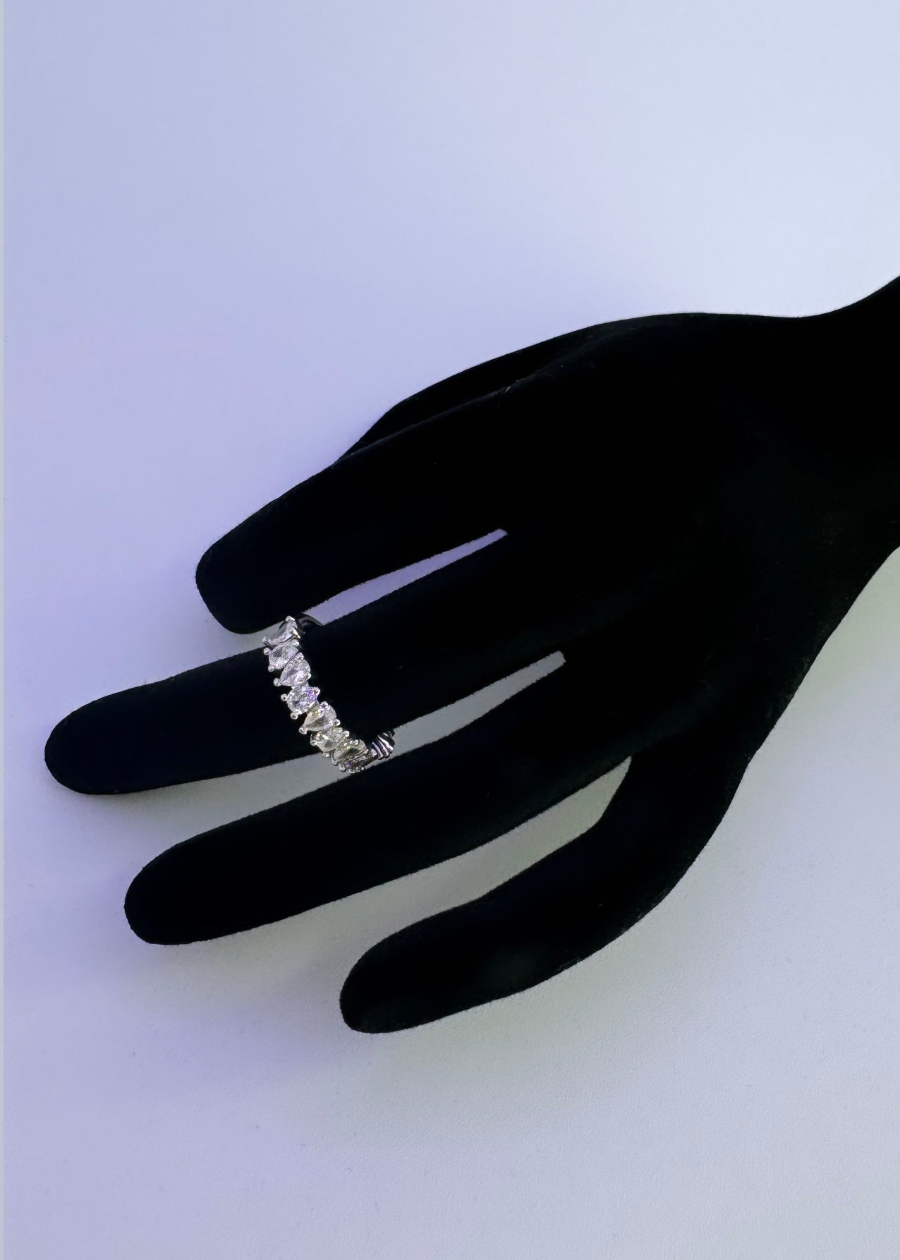 A mini white pear shaped diamond embroidered ring band with 925 inscription inside the band