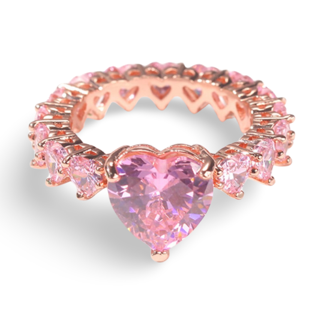 A medium pink large heart shaped central cz diamond ring with mini pink heart shaped diamonds surrounding the rest of the ring. The ring has rose gold plating, essentially an all heart ring so no band is showing 