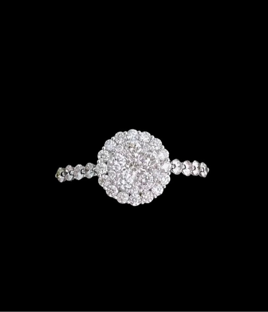 Silver plated ring embroidered with mini white circular diamonds and a larger circular white diamond central piece made of the miniature white circular diamonds 