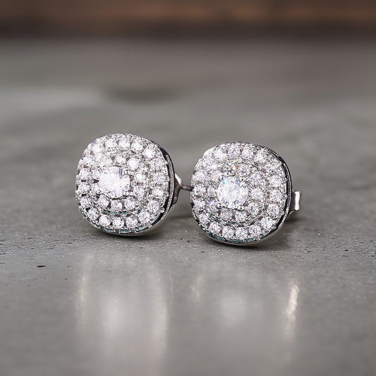 Curved square like studs with mini circular embroidery cz diamonds making up the front of the earring pair. These are all white diamonds followed by silver plating 