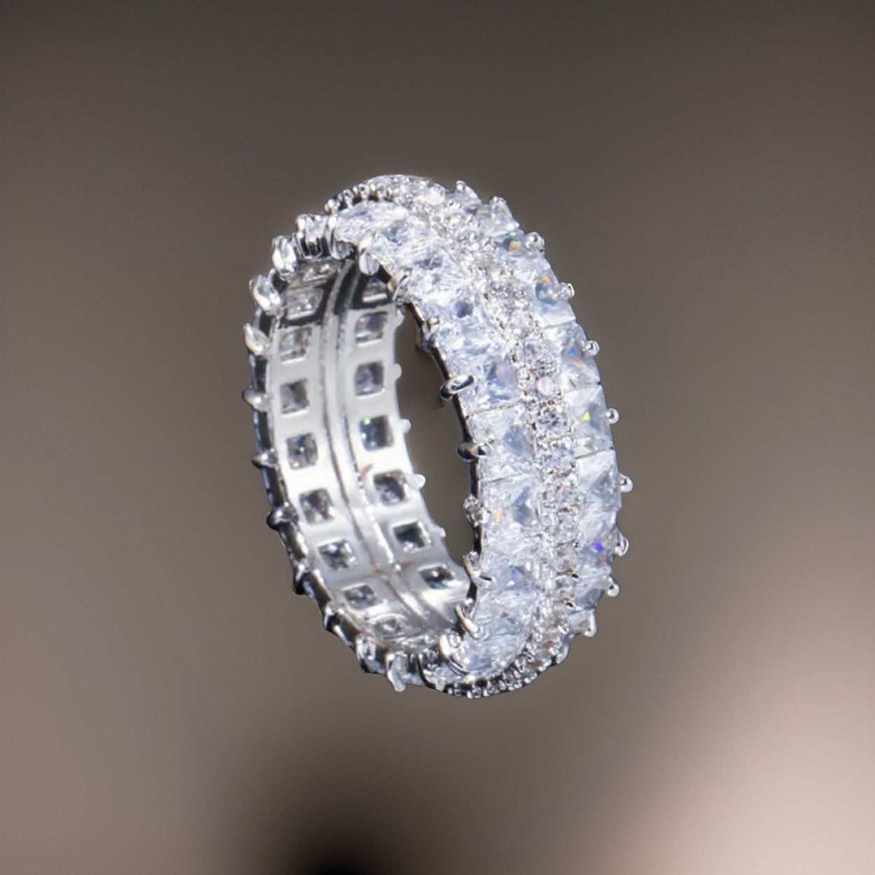 An all white cz diamond embroidered ring band with mini square diamonds going all around the band so the band is hardly visible just the diamonds. The band is silver plated and thick