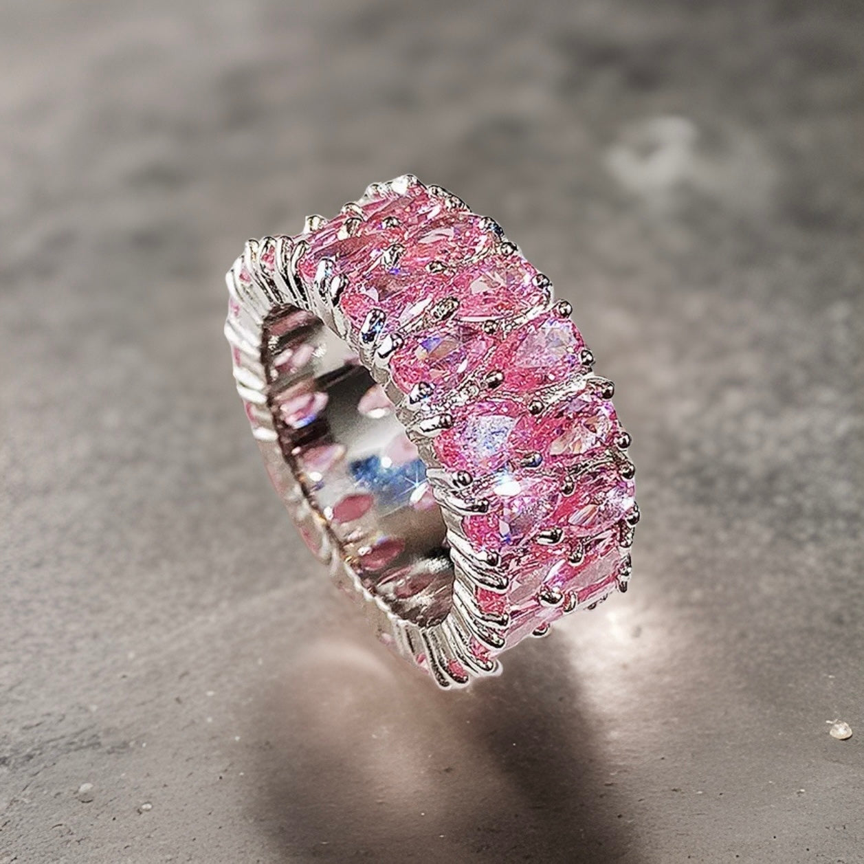 Medium pink pear diamond embroidered ring band. This is a thick ring band with mini pear shaped diamonds going all around the ring so the plating is not that visible apart from on the inside of the ring. The plating is silver 